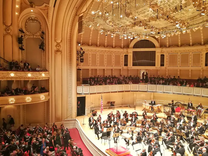 The Chicago Symphony Orchestra on stage in the gilded, horseshoe-shaped Orchestra Hall at Symphony Center.